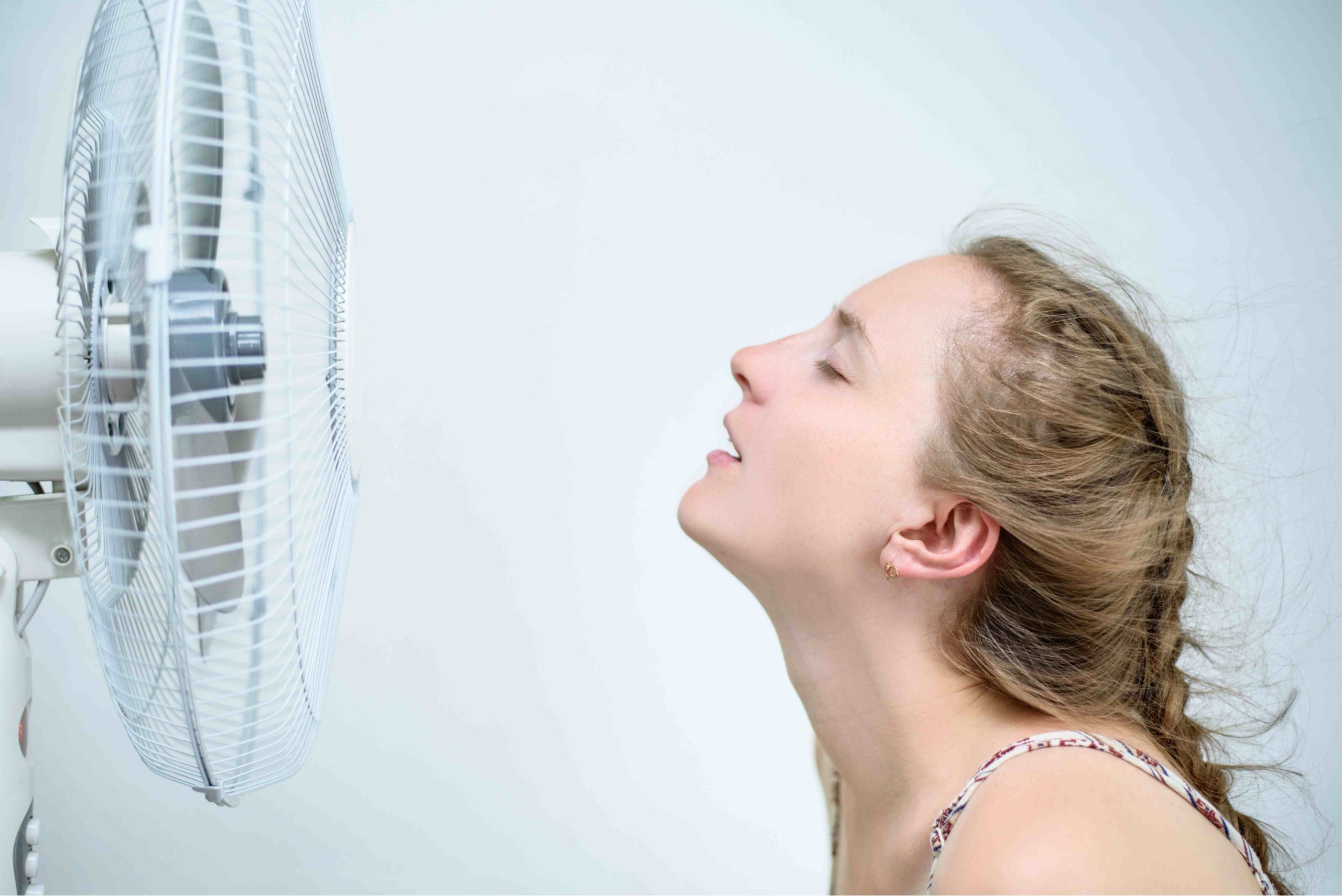Fan blowing air at a Woman