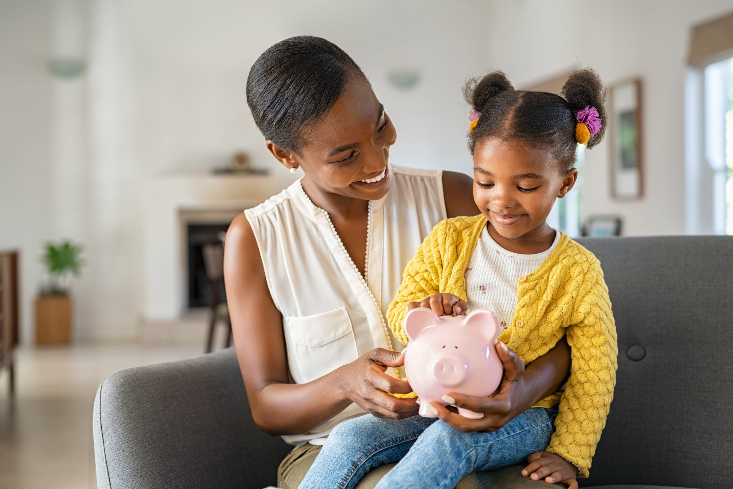 mother daughter savings with piggy bank