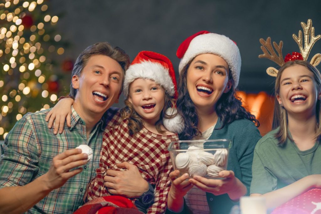 family laughing around the christmas tree