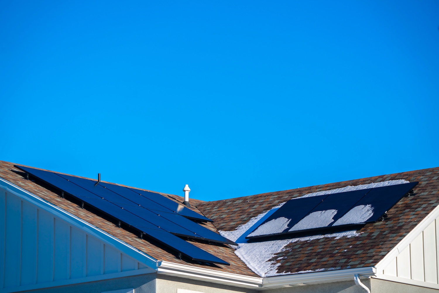 Snow and photovoltaic solar panels on a roof