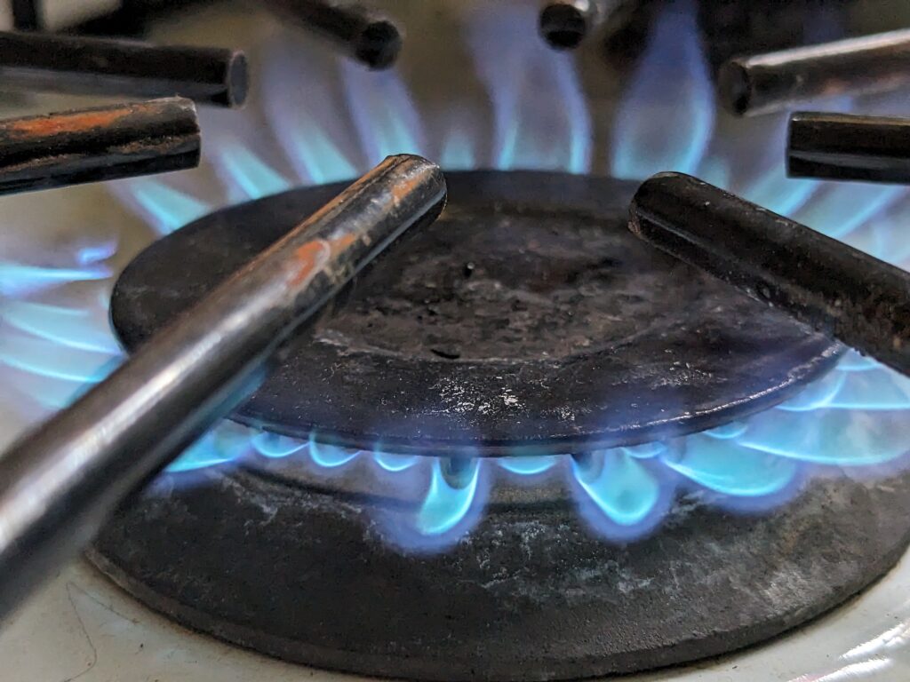 blue flame coming from glass stove