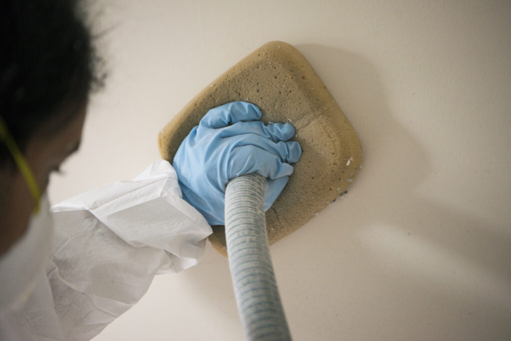 neeeco team member installing insulation in the wall