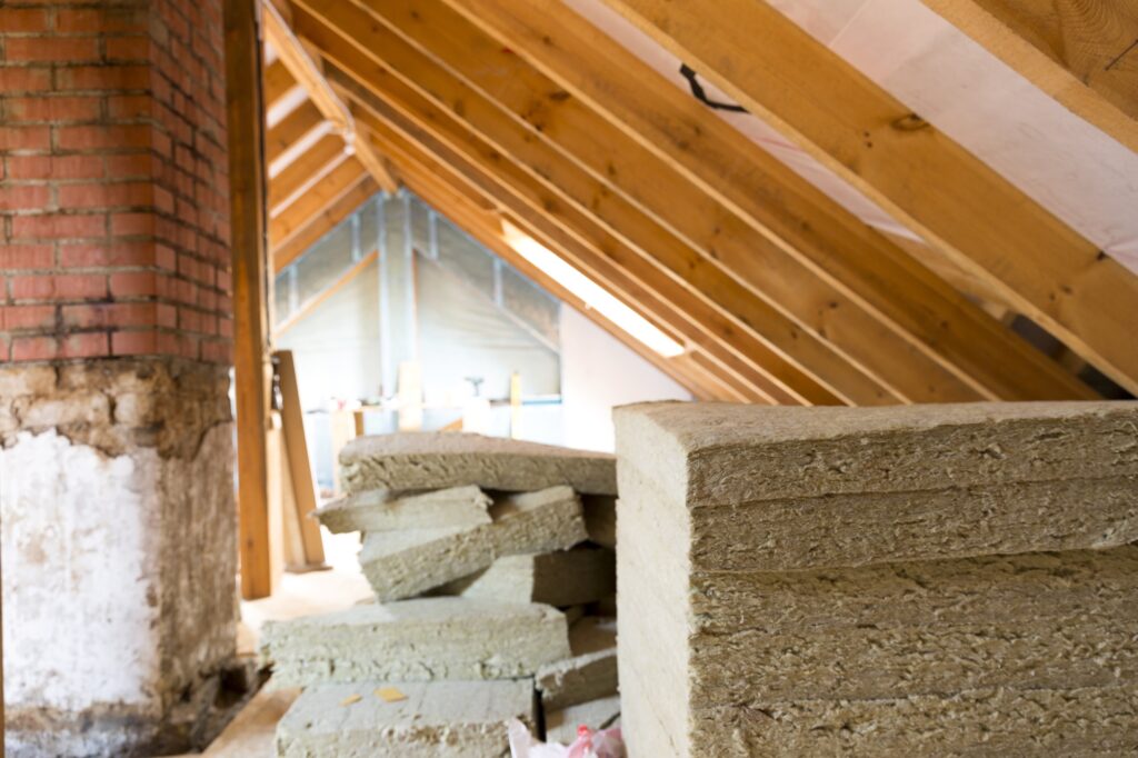 View of attic renovation and construction site with pile of rockwool prepared to be installed