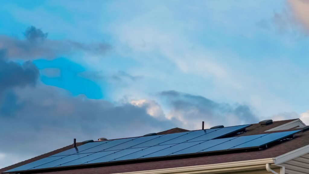 Panorama frame Solar panels installed on the roof of a home with white horizontal wall siding