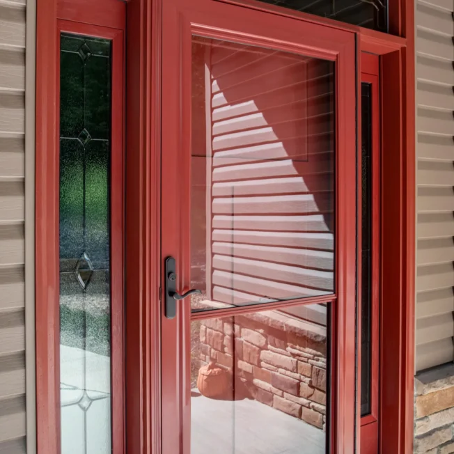 Red external door with red framed storm door