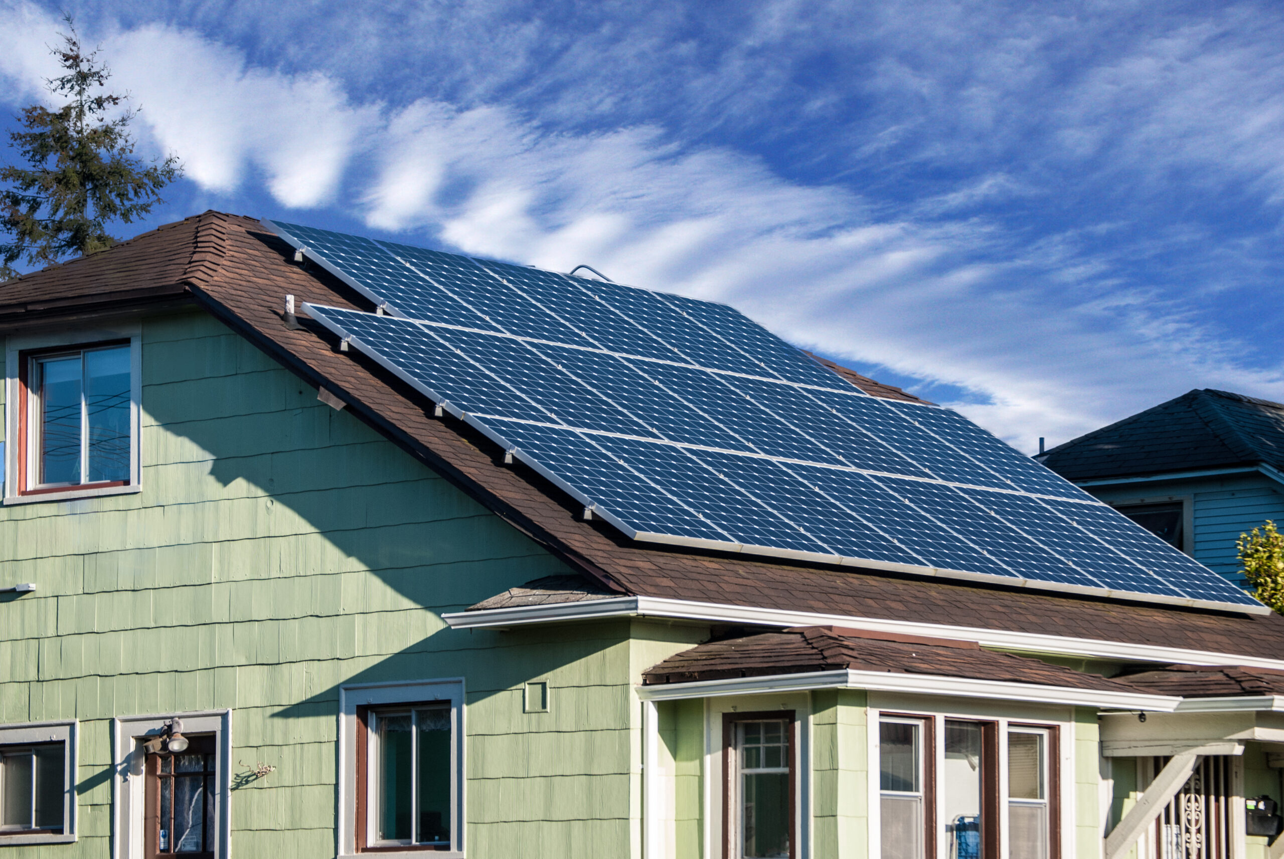 green home with solar panels on the roof