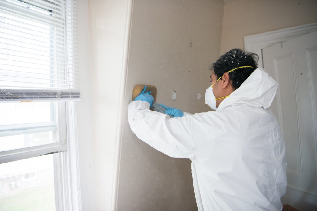 Neeeco team member insulating wall of a bedroom